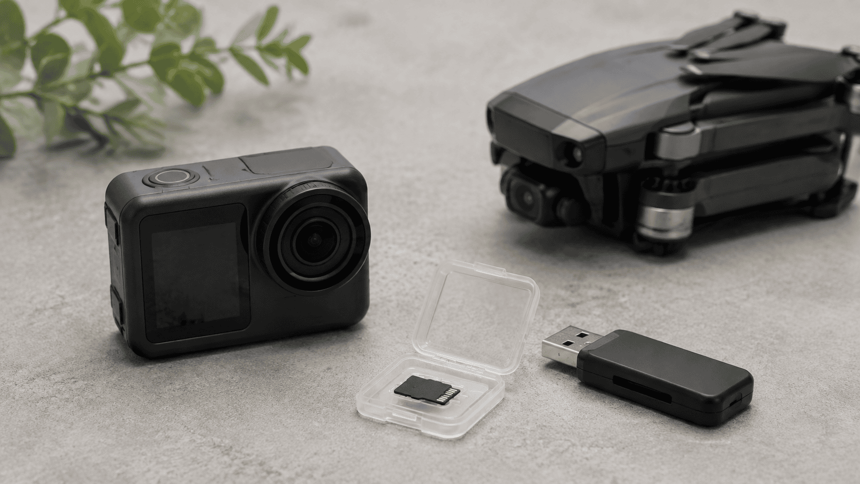 An action camera, protected microSD card and reader with a drone in the background.